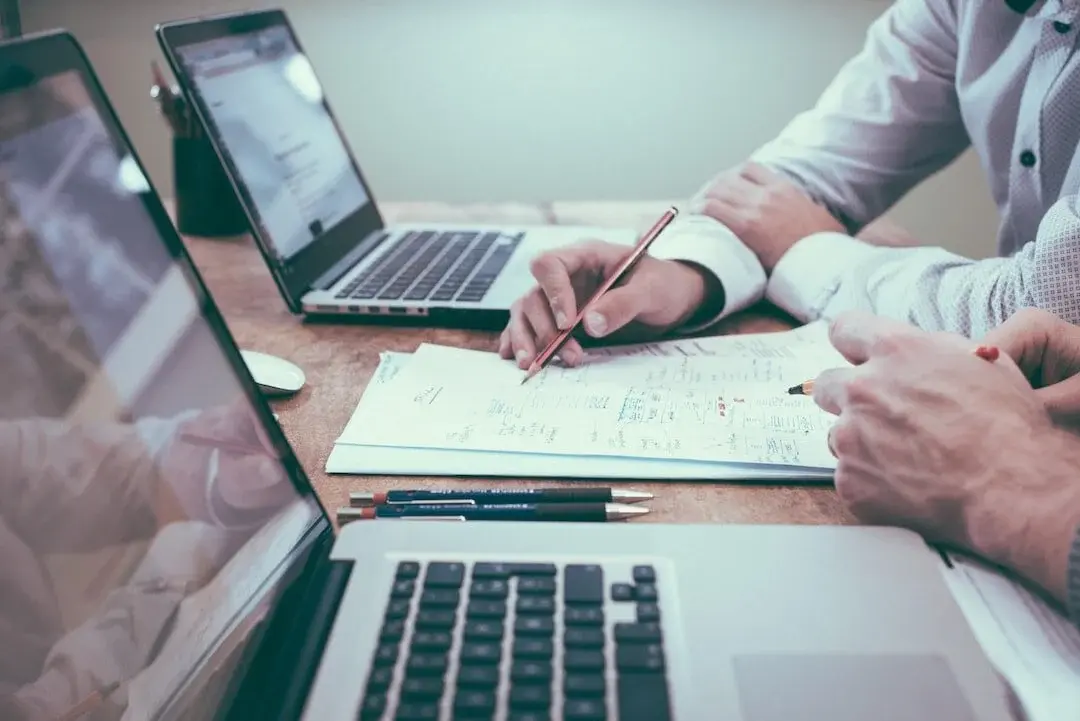 Professionals reviewing data and plans in a relaxed work environment, co-creating a strategic business roadmap.